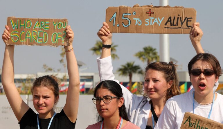 Activists holding 1 5 celsius signage