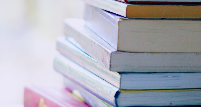 stack of books against blurred backdrop.jpg.optimal
